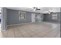Spacious living room featuring tile flooring, neutral paint, and bright windows at 5615 Se 113Th Pl, Belleview, FL 34420