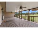 Spacious screened porch with wooden flooring and view of the outdoors at 5615 Se 113Th Pl, Belleview, FL 34420