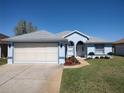Charming single-story home featuring a well-manicured lawn and a welcoming front entrance at 7407 Sw 112Th Pl, Ocala, FL 34476