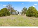 Charming single-story home with a well-manicured lawn, mature landscaping, and a welcoming entrance at 8106 County Road 109, Lady Lake, FL 32159