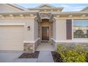 Close-up of the home's entrance showcasing a stylish front door and stone accents at 8899 Sw 50Th Ave, Ocala, FL 34476