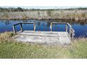 Small private wooden dock with railings, perfect for enjoying the waterfront at 1764 Se 169Th Avenue Rd, Silver Springs, FL 34488