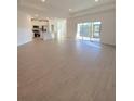 Open-concept living space with tile floors, connecting the living area to the kitchen and outdoor patio at 19444 Sw 78Th Pl, Dunnellon, FL 34432
