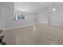 Open-concept living room with tiled floors, recessed lighting, and vaulted ceilings at 3010 Sw 137Th Pl, Ocala, FL 34473