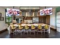 Modern community kitchen with a large island, stainless appliances, and TV screens at 4040 Nw 44Th Cir, Ocala, FL 34482