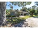 Well-maintained single-story home with a lush front lawn and mature shade trees at 4245 Se 24Th Ter, Ocala, FL 34480