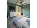 Cozy bedroom featuring a ceiling fan, a dresser, and closet access at 43 Pine Radl, Ocala, FL 34472