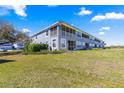 Condominium building with screened patios and a large grassy area at 4401 Sw 52Nd Cir # 110, Ocala, FL 34474