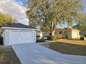 Single-story home boasts a well-manicured lawn, attached garage, and inviting curb appeal at 6767 Sw 114Th Street Rd, Ocala, FL 34476