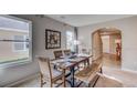 Dining area with wood table and bench seating, light-colored walls, and stylish decor at 8658 Sw 44Th Ter, Ocala, FL 34476