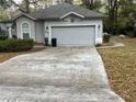 Single Gathering home featuring an attached two car garage and extended driveway at 8775 Sw 192 Ct, Dunnellon, FL 34432