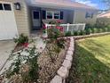 Landscaped front yard with decorative stone and brick borders, plants and small porch at 9380 Sw 84Th Ter # E, Ocala, FL 34481