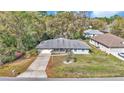 A lovely single-story home with mature trees and an extended driveway at 9844 Sw 198Th Cir, Dunnellon, FL 34432