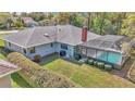 This backyard features a screened-in pool, trimmed hedges and a well-manicured lawn at 9844 Sw 198Th Cir, Dunnellon, FL 34432