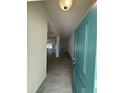 Inviting entryway with a light teal door, ceramic tile flooring and a view into the house at 4397 Sw 90Th Pl, Ocala, FL 34476