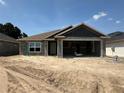 New construction home featuring concrete walls, open garage, and a clean, modern design at 4397 Sw 90Th Pl, Ocala, FL 34476