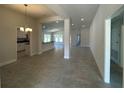 Spacious living room with neutral walls, tile flooring, and abundant natural light at 4397 Sw 90Th Pl, Ocala, FL 34476