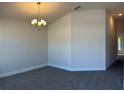 Bright dining room features modern chandelier, neutral walls, and plush carpet, perfect for Gathering meals at 4413 Sw 90Th Pl, Ocala, FL 34476