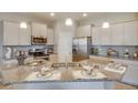 Well-lit kitchen featuring an island with granite countertops and stainless steel appliances at 4755 Nw 39Th Street Rd, Ocala, FL 34482