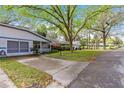 Street view of a well-manicured front yard and mature trees outside this cozy home at 8700 Sw 98Th Street Rd # E, Ocala, FL 34481