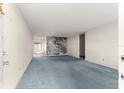 Inviting living room with blue carpeting and a decorative mural accent wall at 8700 Sw 98Th Street Rd # E, Ocala, FL 34481