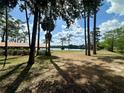 Lush grounds with mature trees and lake views, plus a covered picnic area for outdoor enjoyment and gatherings at 845 Ne 130 Ter, Silver Springs, FL 34488