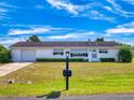 Charming home featuring a well-kept lawn, tasteful landscaping, and a welcoming front entrance at 11197 Sw 79Th Ave, Ocala, FL 34476