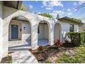 Welcoming front entrance featuring arched openings, providing a unique architectural charm and curb appeal at 2607 Verde Ln, Winter Park, FL 32792