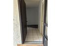 Open doorway with tiled floor leading into a room with wood-look flooring at 532 Bahia Cir # B, Ocala, FL 34472