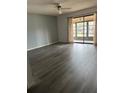 Spacious living room with gray flooring and sliding doors to screened in porch at 532 Bahia Cir # B, Ocala, FL 34472