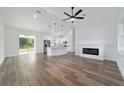 Spacious living room featuring wood-look tile floors, fireplace, and open concept layout at 85 Willow Rd, Ocala, FL 34472