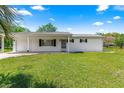 Charming single-story home with a well-maintained front lawn and an attached garage at 10780 Sw 62Nd Avenue Rd, Ocala, FL 34476