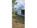 A view of the backyard of the property including a shed and a partial view of the home at 10934 Luana Dr, Leesburg, FL 34788