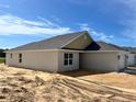 Side view of a single-Gathering home showing the garage and neutral stucco exterior at 4498 Sw 90Th Lane Rd, Ocala, FL 34476