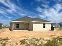 Rear exterior of home showing windows and door, plus AC unit at 4498 Sw 90Th Lane Rd, Ocala, FL 34476