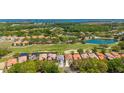 Scenic aerial view showcases a community with a golf course, ponds, and beautiful single-Gathering homes at 9307 San Jose Blvd, Howey In The Hills, FL 34737