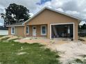New construction home with light tan exterior, white trim, and attached single car garage at 2147 Sw 3Rd St, Ocala, FL 34471