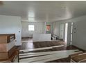 Spacious living room with wood-look flooring, fresh paint, and natural light at 2147 Sw 3Rd St, Ocala, FL 34471