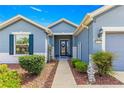 Charming single-story home featuring a well-manicured lawn and welcoming front entrance with attractive landscaping at 9230 Sw 66Th Loop, Ocala, FL 34481