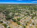 An aerial view of a home situated in a neighborhood of tree-lined streets and well-maintained residences at 10954 Sw 83Rd Ct, Ocala, FL 34481