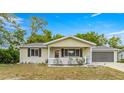 Inviting home featuring neutral siding, a cozy porch, and an attached garage offering both charm and practicality at 10954 Sw 83Rd Ct, Ocala, FL 34481