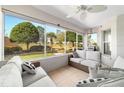 Enclosed sunroom with patio furniture and views of the backyard at 8968 Sw 98Th Ave, Ocala, FL 34481