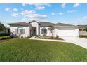 Charming single-story home with manicured lawn and inviting front yard seating area at 2380 Nw 55Th Avenue Rd, Ocala, FL 34482