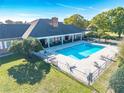 Aerial view of a community pool area with lounge chairs, tables, and landscaping at 3275 Nw 44Th Ct, Ocala, FL 34482