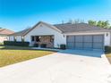 Charming single-story home with a two-car garage, concrete driveway and manicured landscaping at 3275 Nw 44Th Ct, Ocala, FL 34482