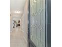 The tiled foyer features a decorative glass front door and a view into the home's living area at 3935 Nw 46Th Ter, Ocala, FL 34482