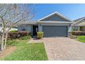 Charming single-Gathering home with a two-car garage, manicured landscaping, and a brick paver driveway at 3935 Nw 46Th Ter, Ocala, FL 34482