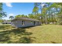 Spacious backyard with lush green lawn and ample shade trees at 4585 Se 136Th St, Summerfield, FL 34491