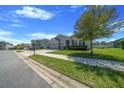 Charming single-Gathering home with a well-manicured lawn, lush landscaping, and a three-car garage at 5048 Sw 57Th Pl, Ocala, FL 34474