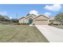 Beautiful one-story home with a two-car garage, lush lawn and a bright blue front door at 6 Diamond Cove Ct, Ocala, FL 34472